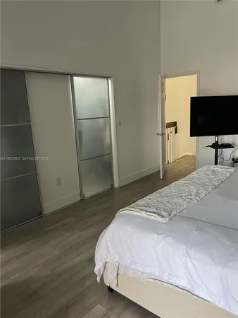 a view of a hallway with wooden floor and furniture