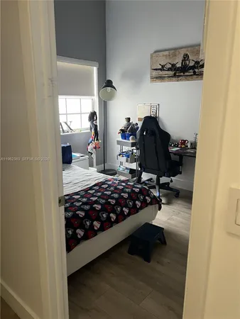 a bedroom with bed and a window