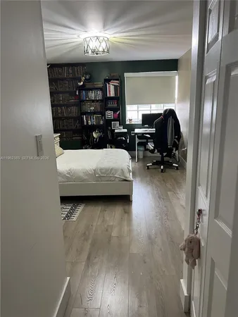 a bedroom with a bed and a book shelf