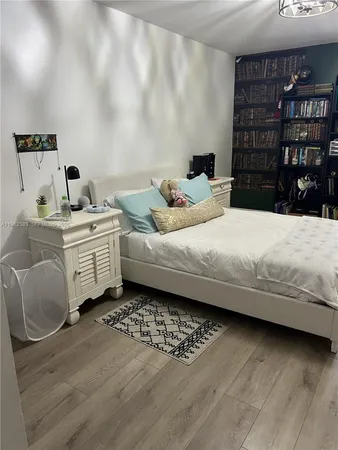 a bedroom with a bed and a book shelf