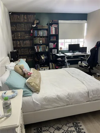 a bedroom with a bed and cabinets