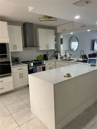 a kitchen with stainless steel appliances granite countertop a sink and cabinets