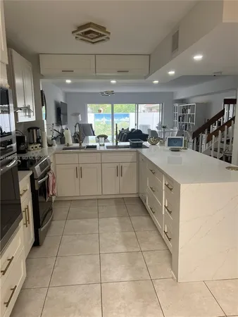 a kitchen with a white cabinets and white appliances