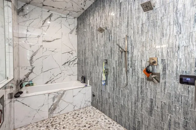 a bathroom with a bathtub and shower