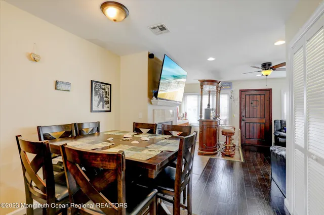 a view of a dining room with furniture and wooden floor