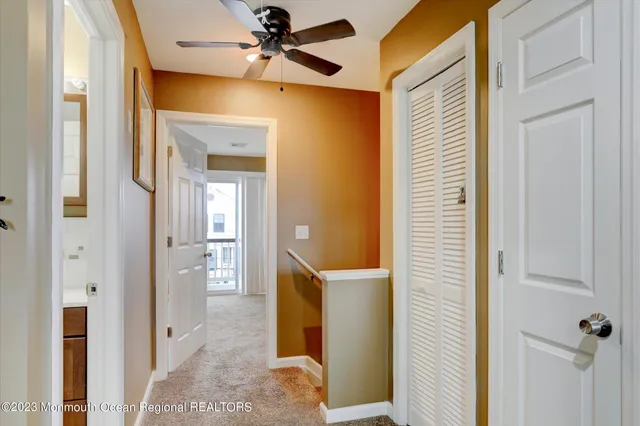 a view of a hallway with a door and stairs