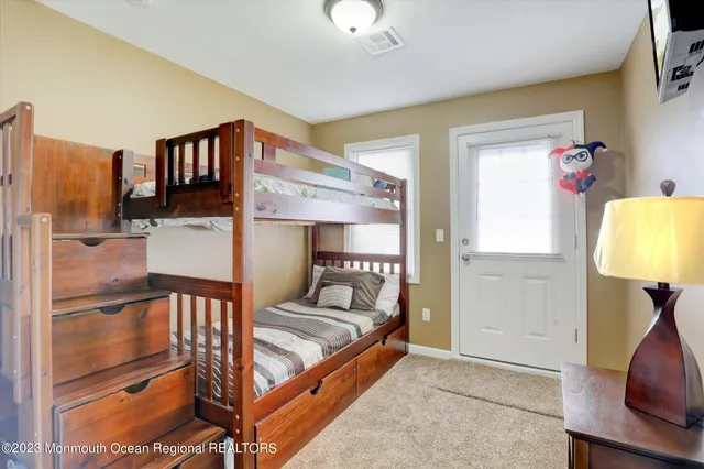 a bed room with a bed and a lamp on desk