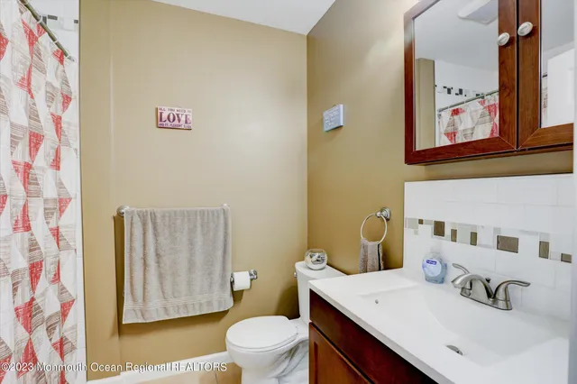 a bathroom with a sink mirror vanity and toilet