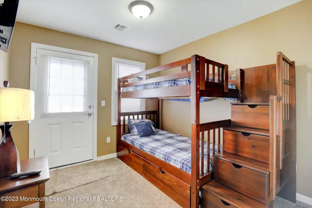 a view of kitchen with furniture and refrigerator