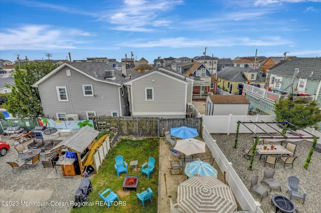 an aerial view of a house with a yard and seating space