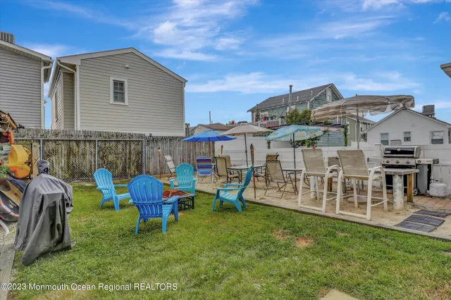 a view of a house with patio and a yard