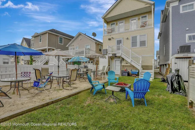a view of a house with a yard and sitting area