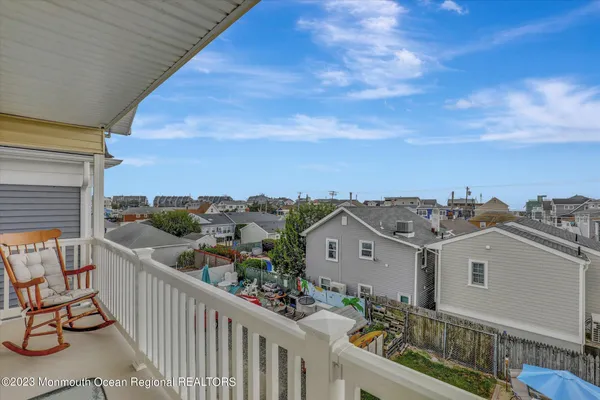 a kitchen with stainless steel appliances kitchen island granite countertop a dining table chairs and a refrigerator