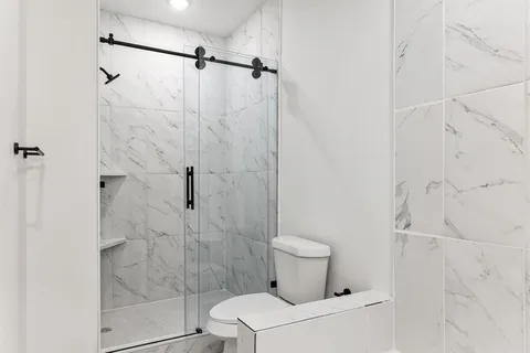 a bathroom with a toilet and shower