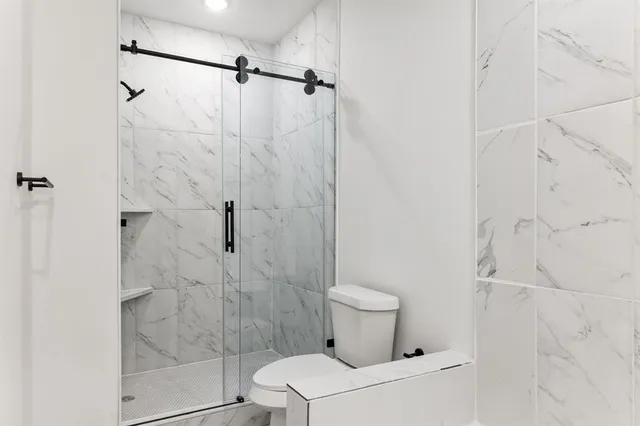 a bathroom with a toilet and shower