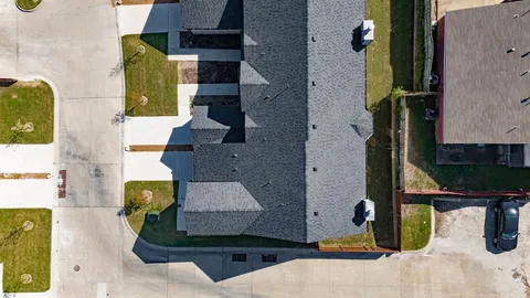 an aerial view of residential houses with outdoor space
