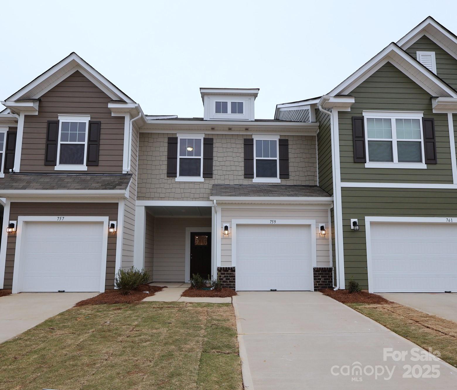 759 Kitfox Drive Northwest Concord, NC 28027 - Photo 1 of 19 a front view of a house with a yard and garage