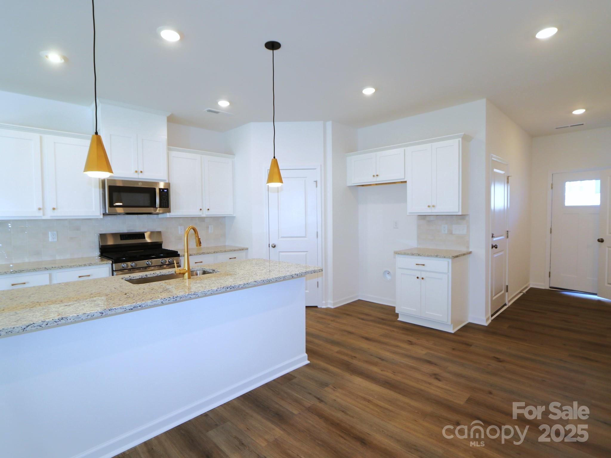 759 Kitfox Drive Northwest Concord, NC 28027 - Photo 3 of 19 a kitchen with a sink stainless steel appliances and cabinets