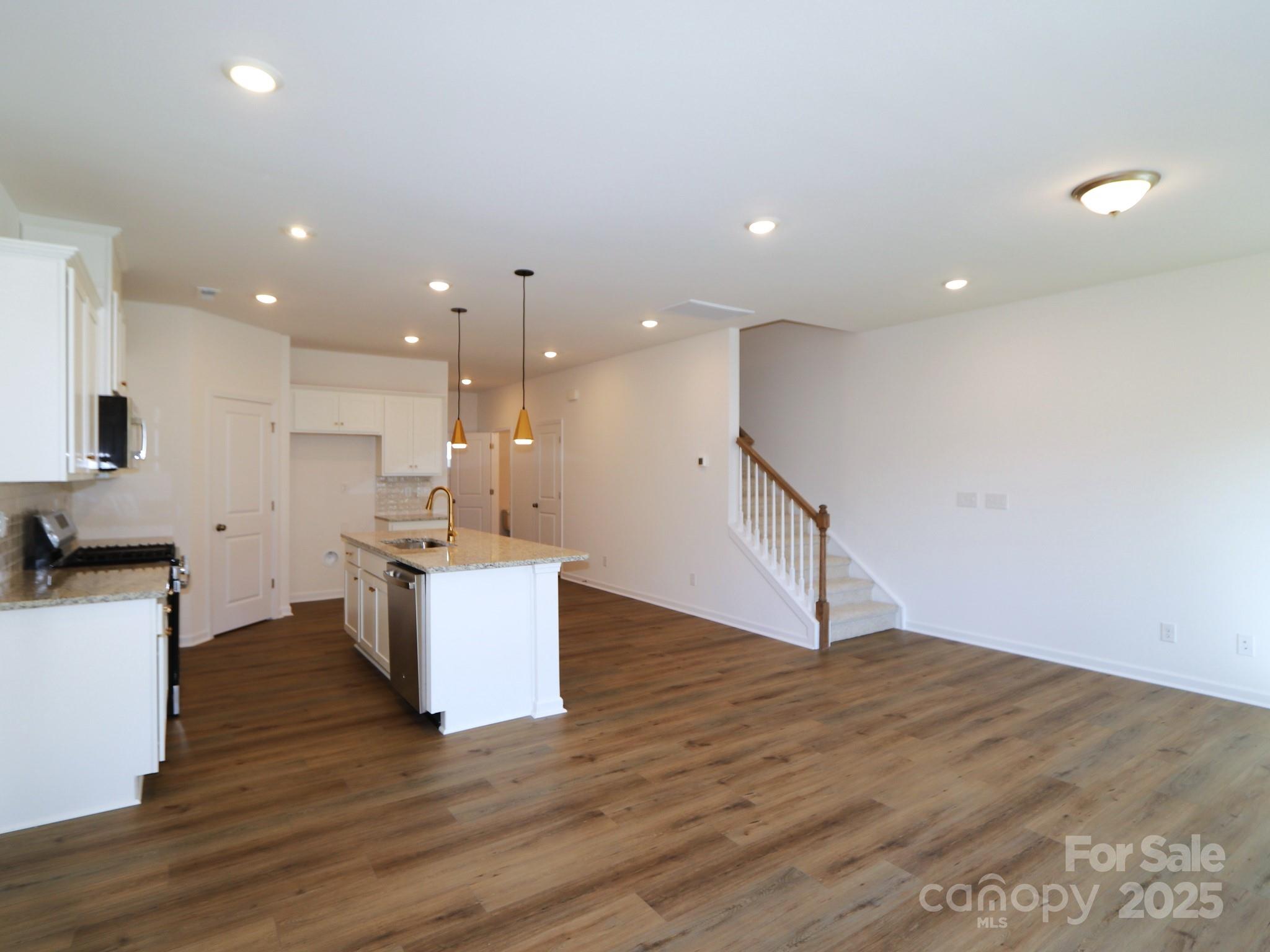 759 Kitfox Drive Northwest Concord, NC 28027 - Photo 8 of 19 a view of kitchen with wooden floor and electronic appliances