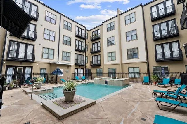 a patio with a table and chairs potted plants