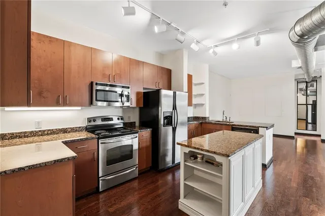 a kitchen with a stove a sink and a microwave