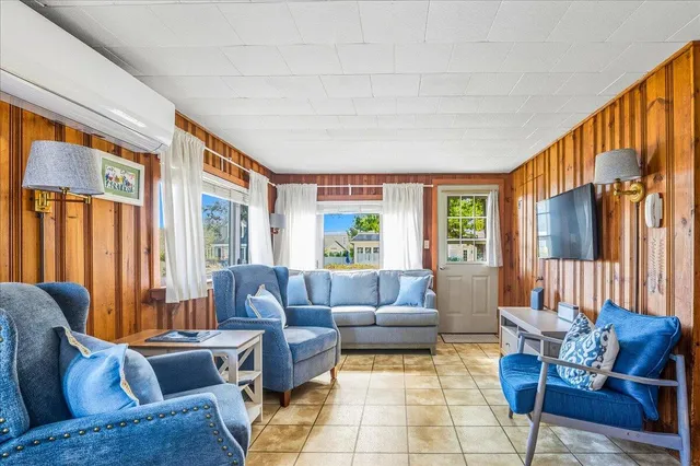 a living room with furniture and large windows