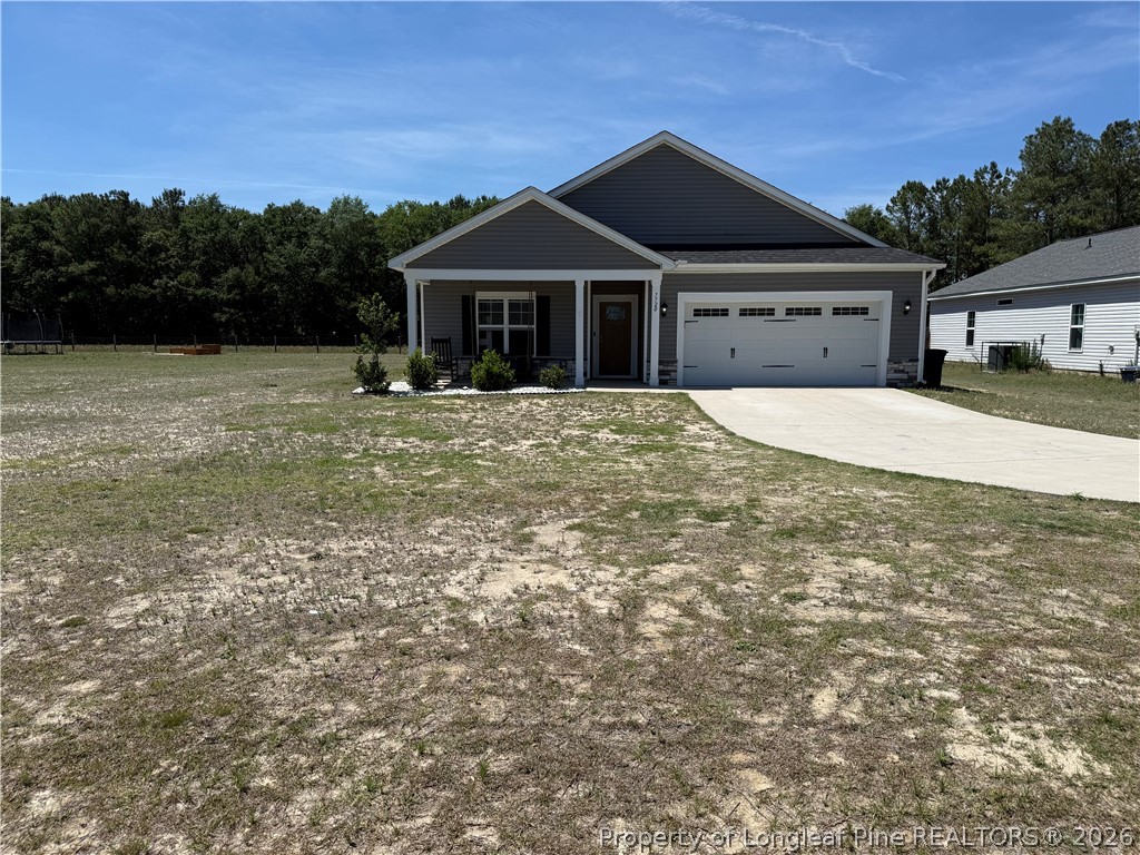 7720 Rufus Johnson Road Fayetteville, NC 28306 - Photo 2 of 50 a front view of a house with a garden and yard