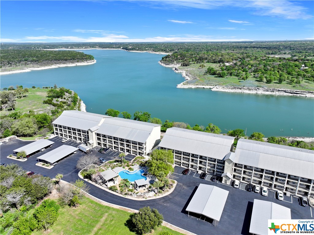 an aerial view of a house with a garden and lake view