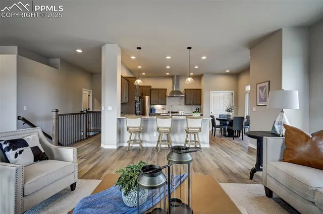 a living room with furniture and kitchen view