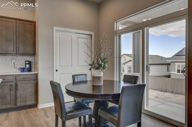 a view of a dining room with furniture and a potted plant