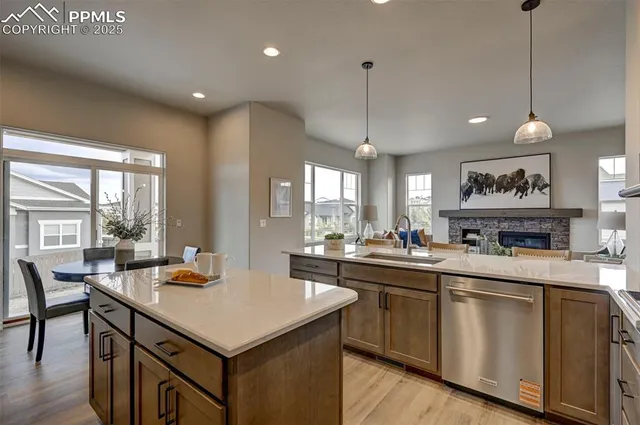 a kitchen with a stove a counter space dining table and chairs