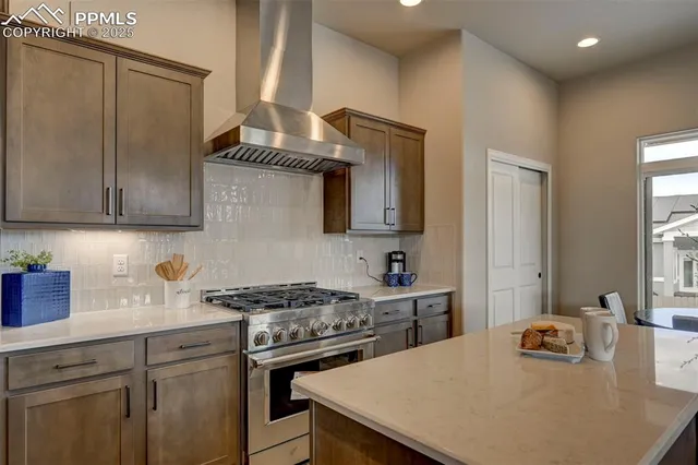 a kitchen with a stove a sink and cabinets