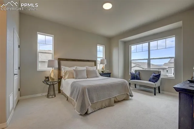 a bedroom with a bed and a large window