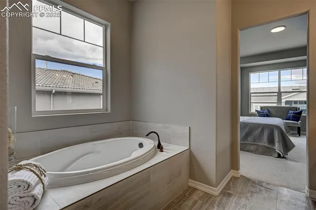 a bathroom with a tub and a window