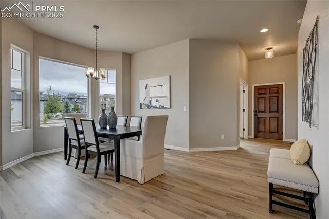 a dining room with furniture and wooden floor
