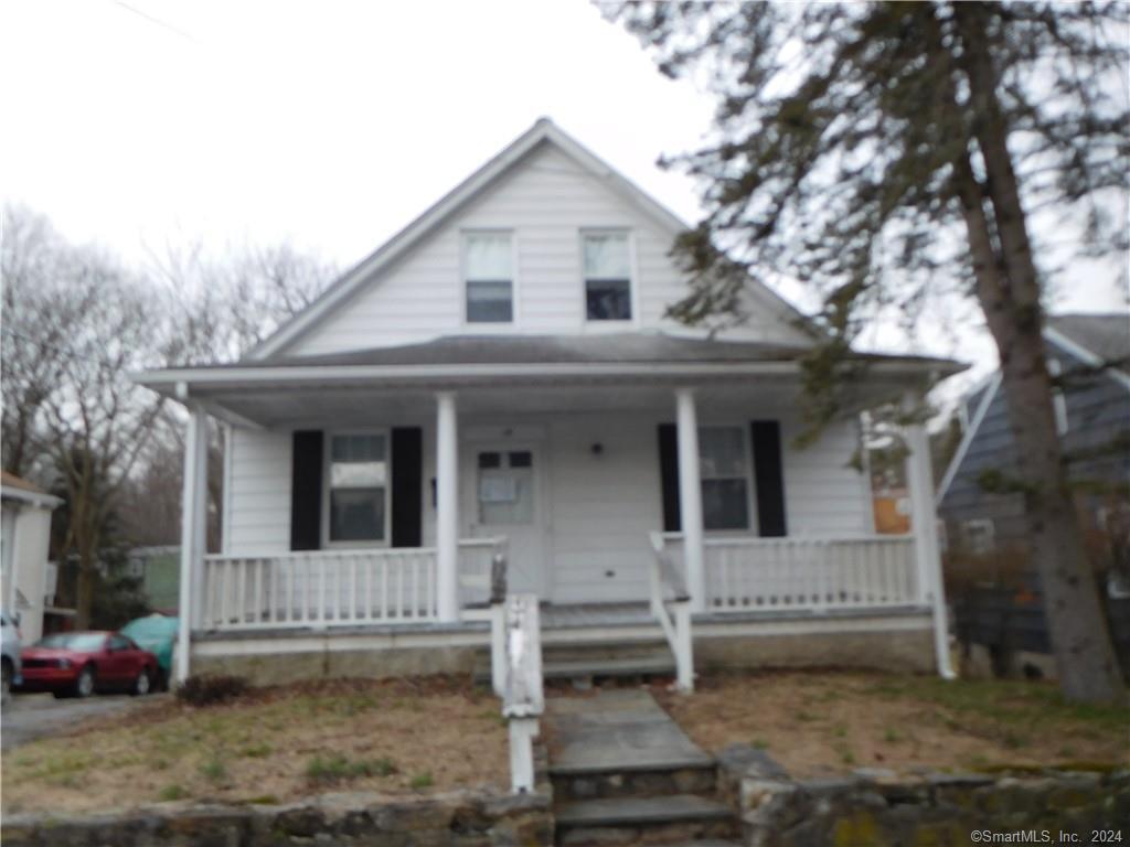 15 Ridgeway Street Stamford, CT 06907 - Photo 1 of 1 a view of a white house with large windows and a small yard