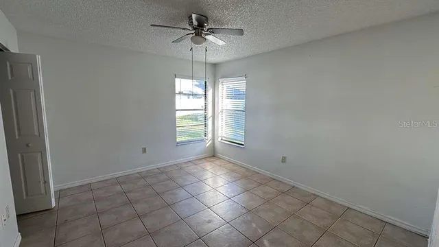 a view of a livingroom with a ceiling fan and window