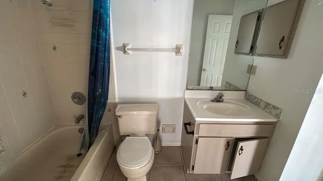 a white toilet sitting next to a bathroom sink