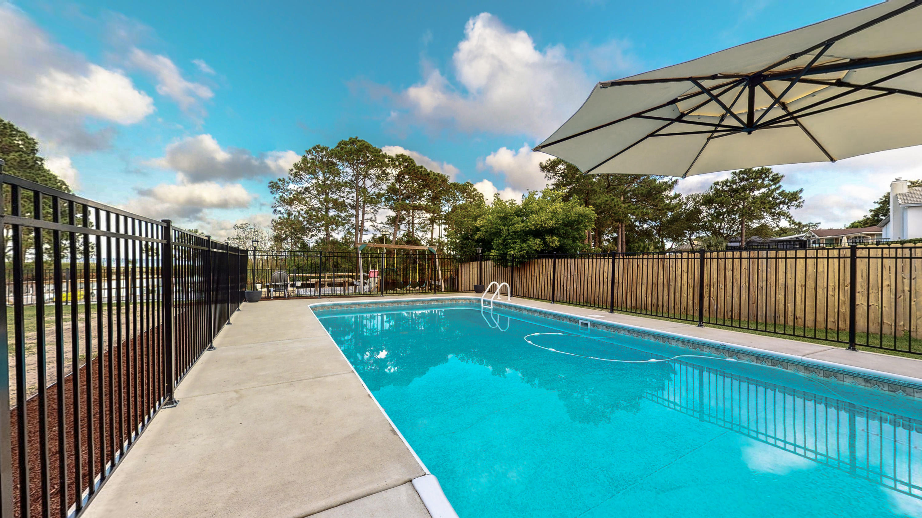 37 Country Club Road Shalimar, FL 32579 - Photo 3 of 64 a view of a backyard with a iron fence