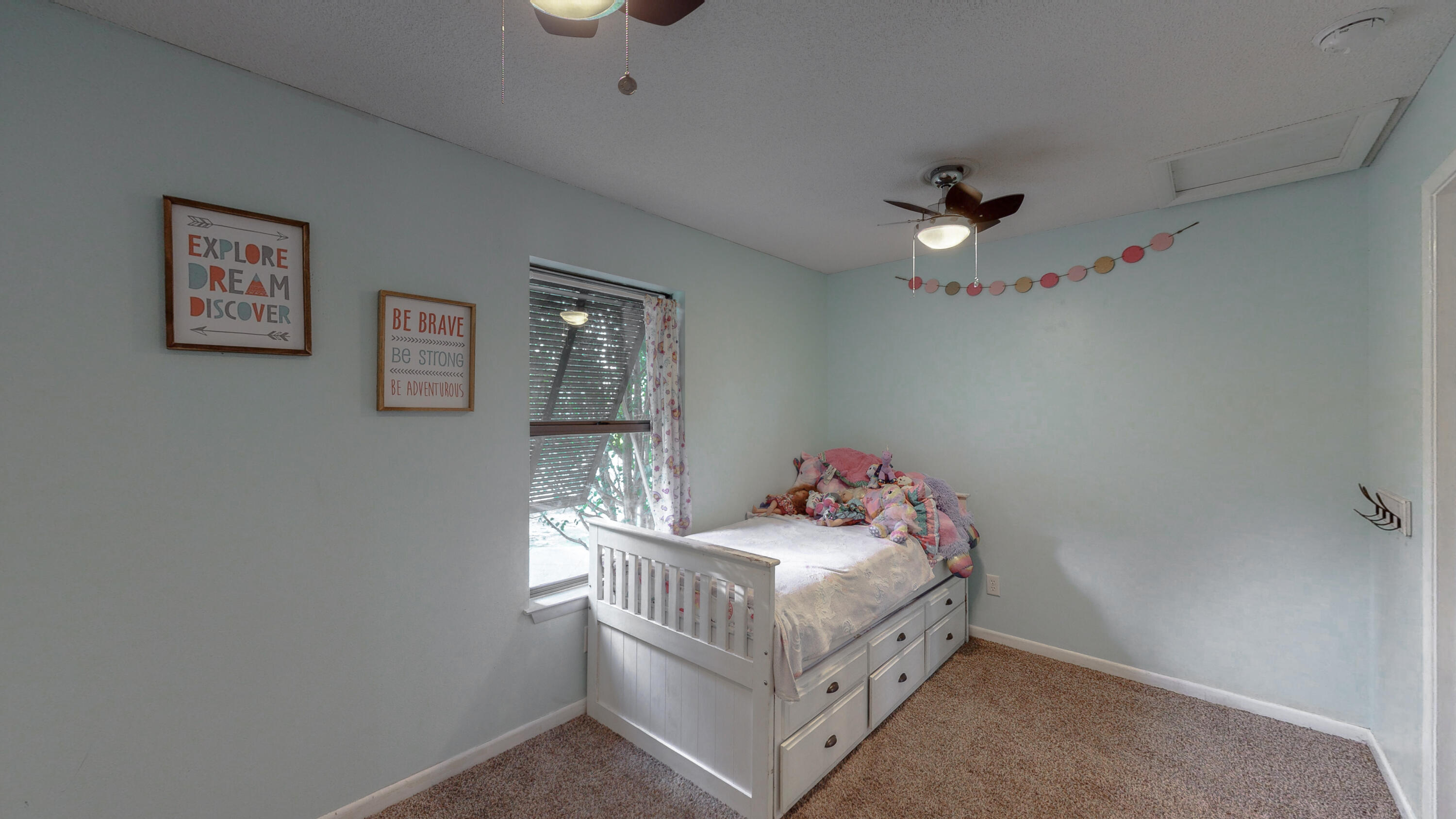 37 Country Club Road Shalimar, FL 32579 - Photo 35 of 64 a bedroom with a bed and a chandelier
