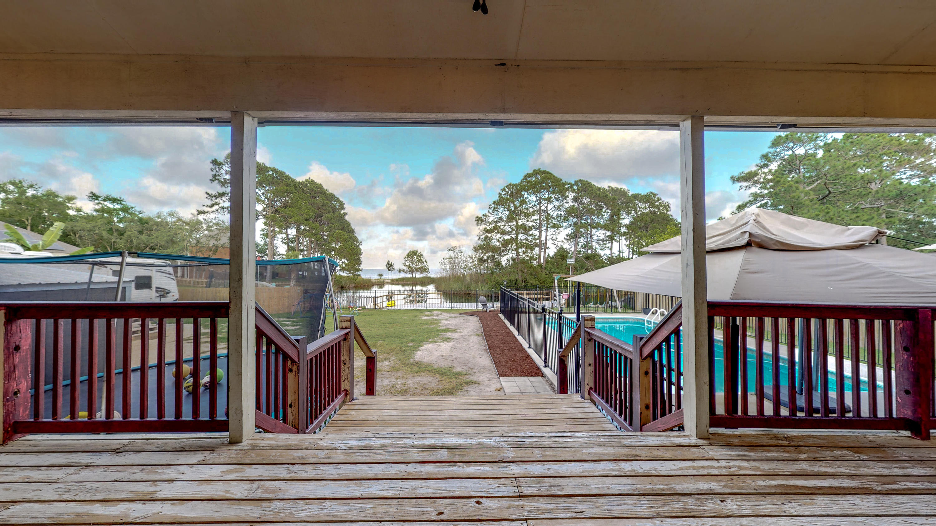 37 Country Club Road Shalimar, FL 32579 - Photo 54 of 64 a view of a balcony with lake view and wooden floor