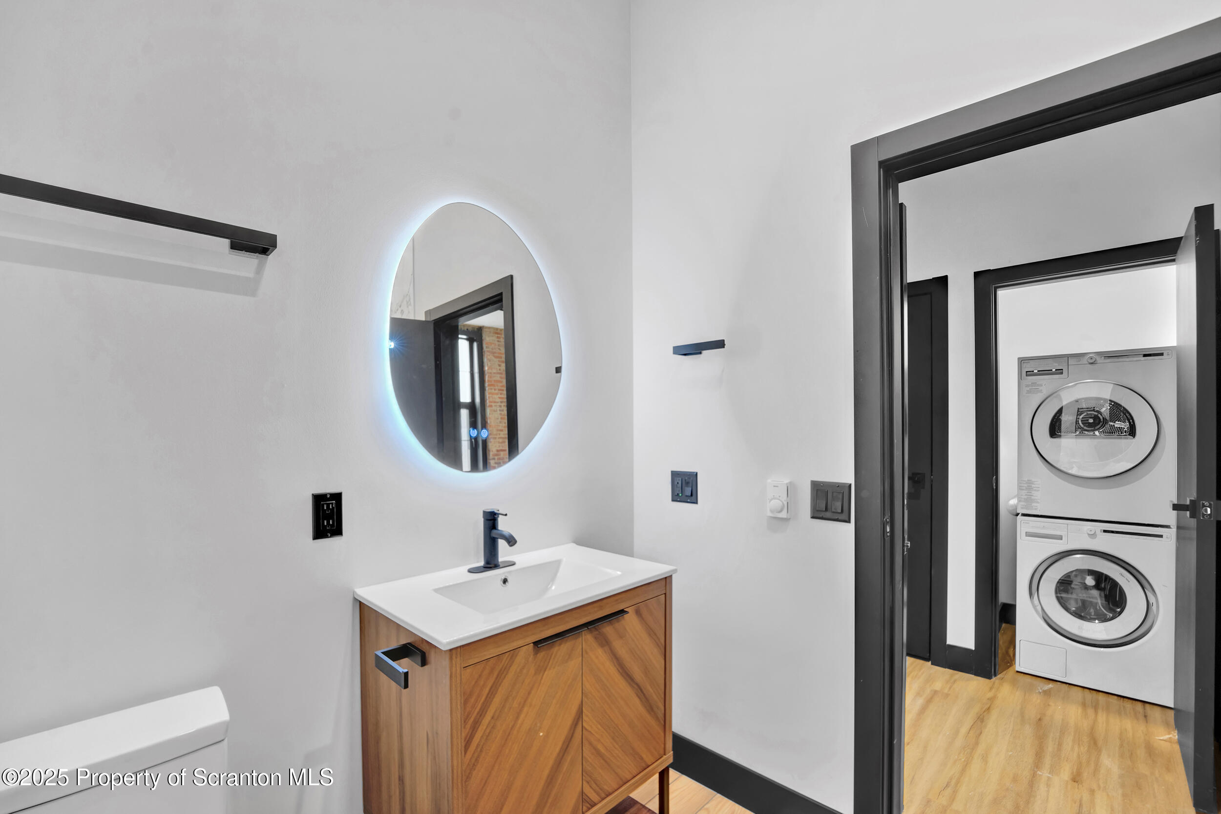 115 Penn Avenue, Unit 202 Scranton, PA 18503 - Photo 16 of 60 a bathroom with a sink a mirror and a toilet