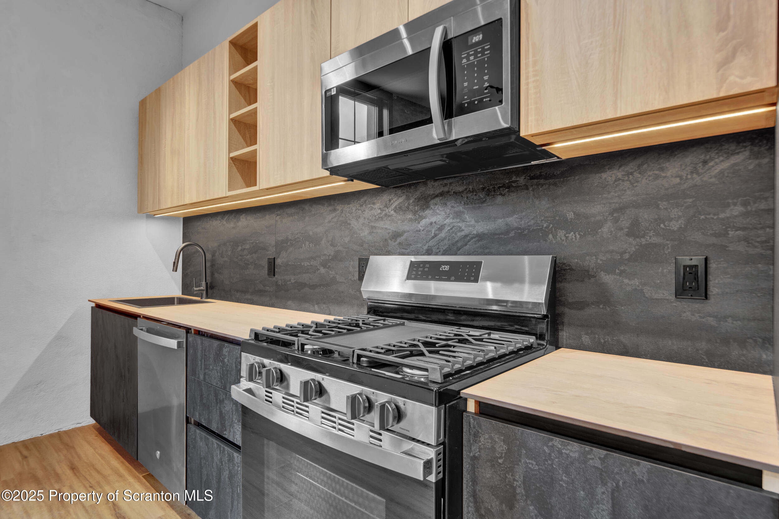 115 Penn Avenue, Unit 202 Scranton, PA 18503 - Photo 23 of 60 a kitchen with stainless steel appliances granite countertop a stove and a microwave