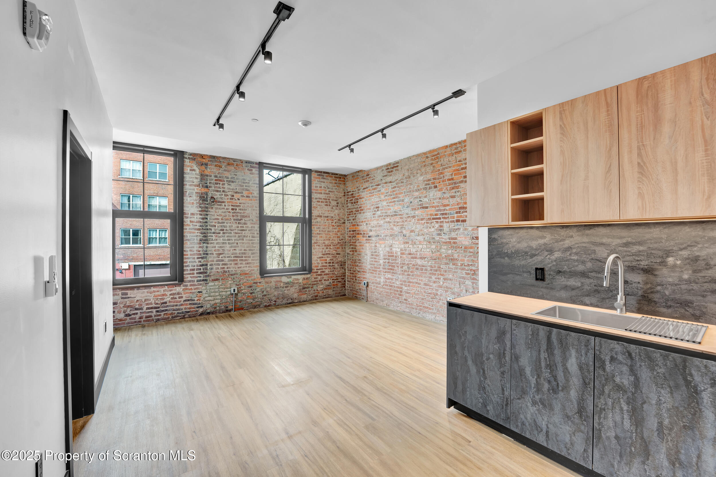 115 Penn Avenue, Unit 202 Scranton, PA 18503 - Photo 28 of 60 a view of an empty room with a window and wooden floor