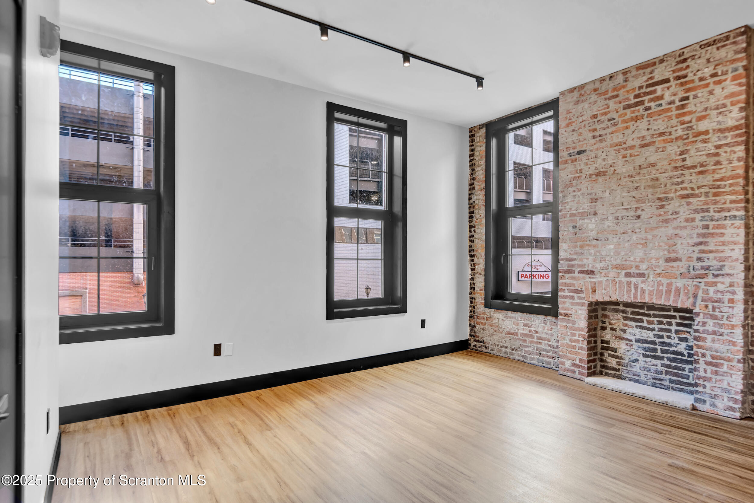 115 Penn Avenue, Unit 202 Scranton, PA 18503 - Photo 5 of 60 a view of an empty room with wooden floor and a window
