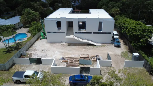 a aerial view of a house with a yard and garage