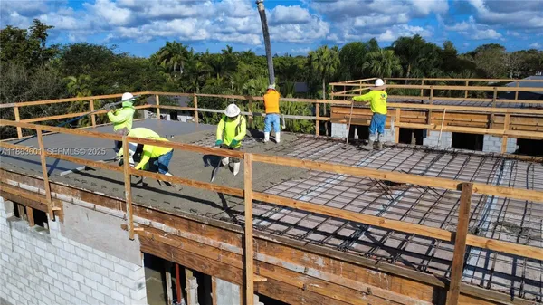 a view of balcony with wooden floor and fence