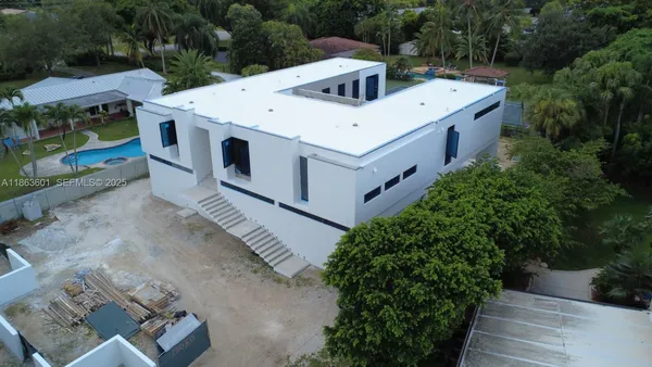 an aerial view of a house with a yard and garage