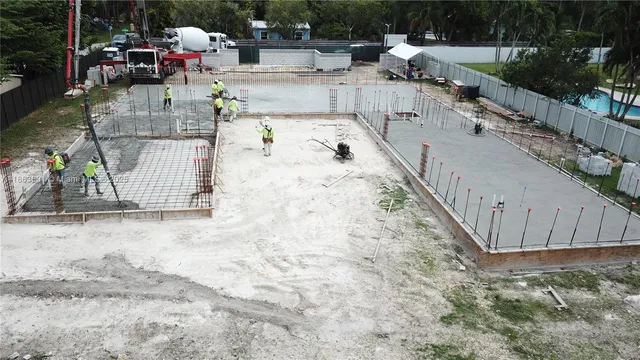 a view of a backyard with wooden fence