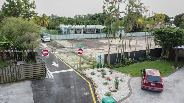a view of a backyard with wooden fence